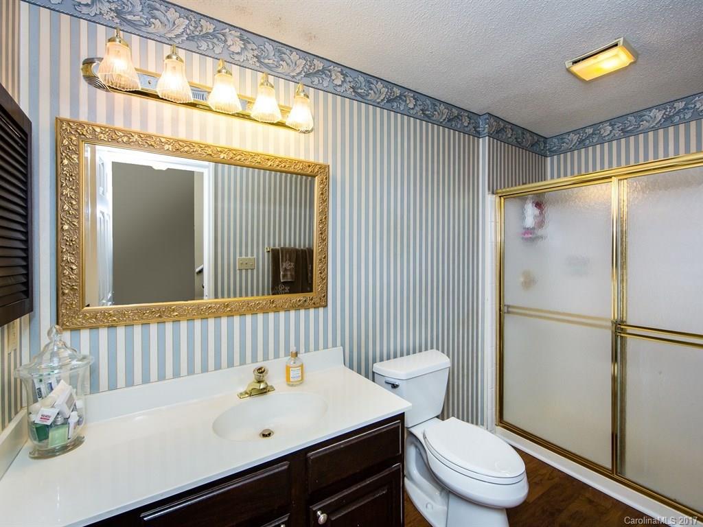 5003 Sharon Road, Unit B Charlotte, NC 28210 - Photo 16 of 20 a bathroom with a sink a toilet and shower