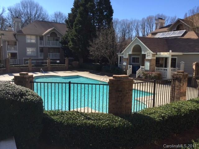 5003 Sharon Road, Unit B Charlotte, NC 28210 - Photo 20 of 20 a front view of house with yard and trees in the background