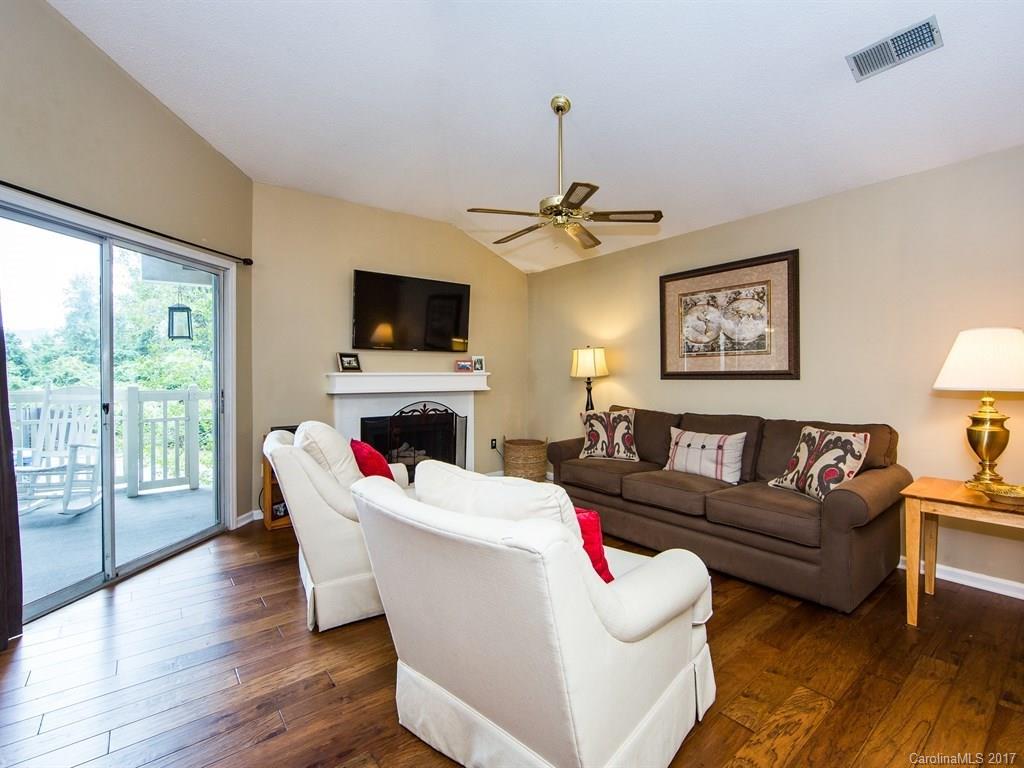 5003 Sharon Road, Unit B Charlotte, NC 28210 - Photo 4 of 20 a living room with furniture a flat screen tv and a fireplace
