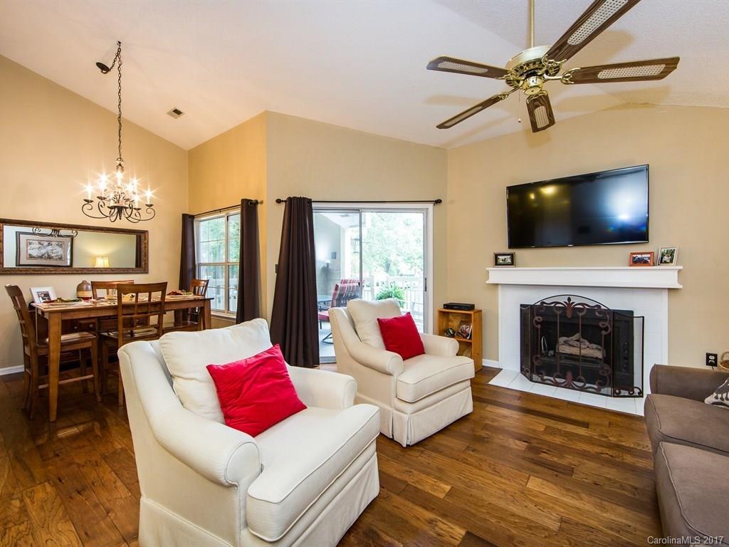 5003 Sharon Road, Unit B Charlotte, NC 28210 - Photo 5 of 20 a living room with furniture a fireplace and a flat screen tv