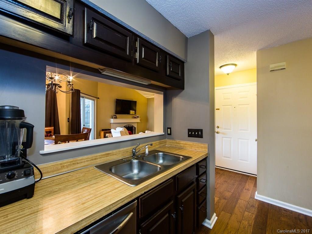 5003 Sharon Road, Unit B Charlotte, NC 28210 - Photo 8 of 20 a kitchen with a sink and wooden floor