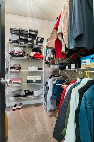 a view of a livingroom with furniture and a chandelier fan