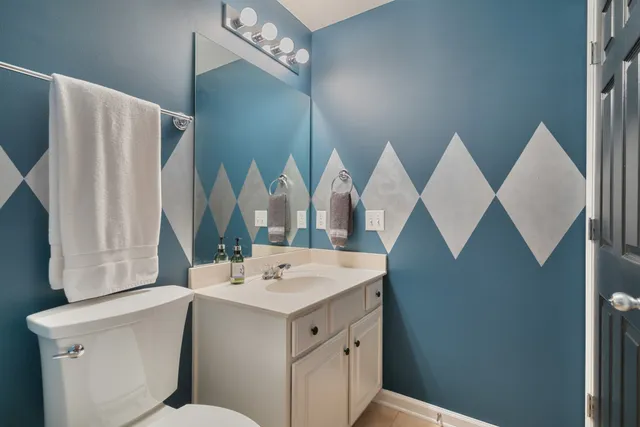 a living room with a table chairs and a wooden floor