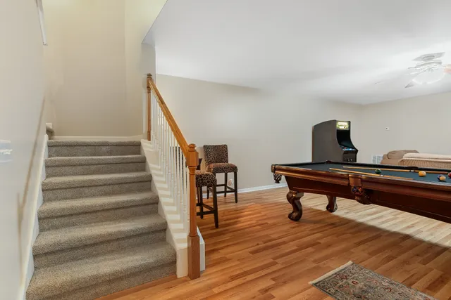 an aerial view of a house with a yard and lake view