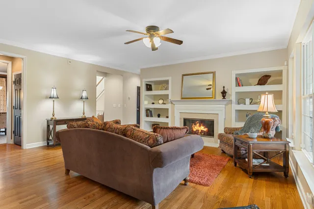 a kitchen with stainless steel appliances granite countertop a stove top oven a sink dishwasher a dining table and chairs with wooden floor