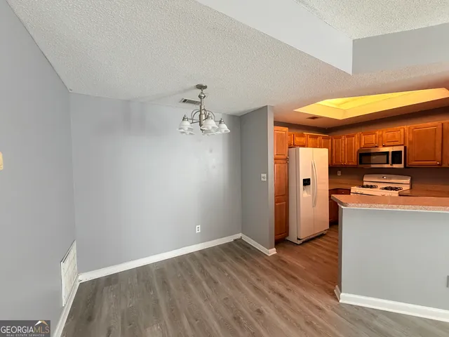 a view of a kitchen with wooden floor
