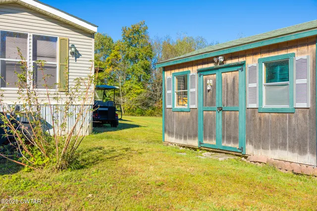 a backyard of a house with a garden and tree