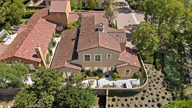 an aerial view of a house with backyard and outdoor seating