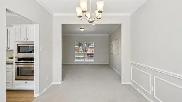 a view of an empty room with a kitchen
