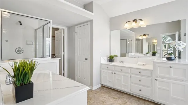 a bathroom with a double vanity sink and a mirror