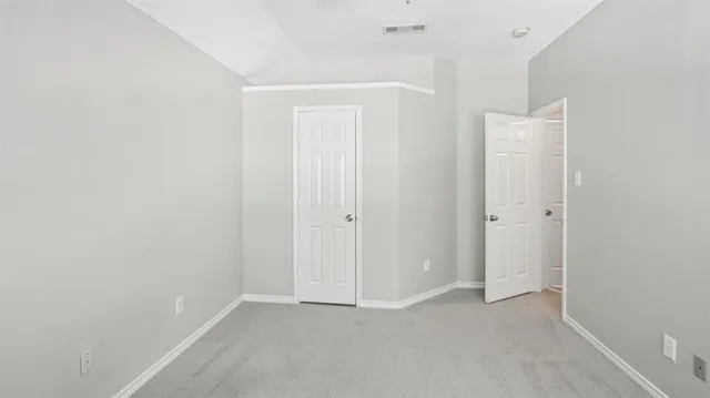 an empty room with closet area