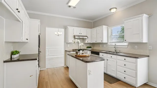 a kitchen with a stove a sink and a refrigerator