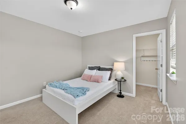 a bedroom with a bed and lamp