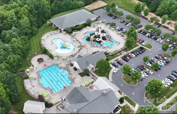 an aerial view of a house with garden space and street view
