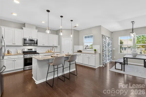 a kitchen with a sink cabinets and wooden floor