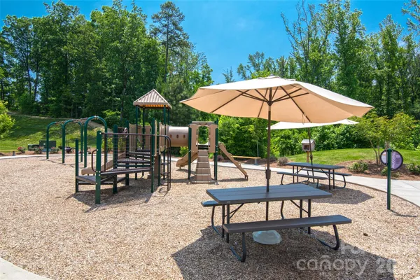 an outdoor space with patio and white umbrellas