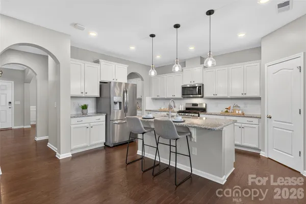 a kitchen with a refrigerator a sink and cabinets