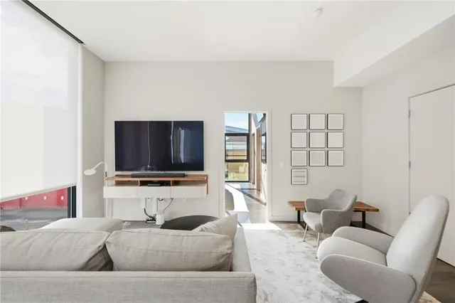 a bedroom with a large bed and a large window