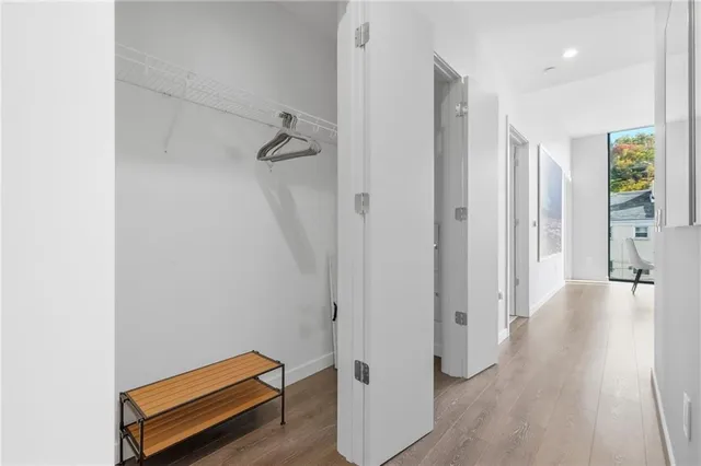 a large white kitchen with a large window