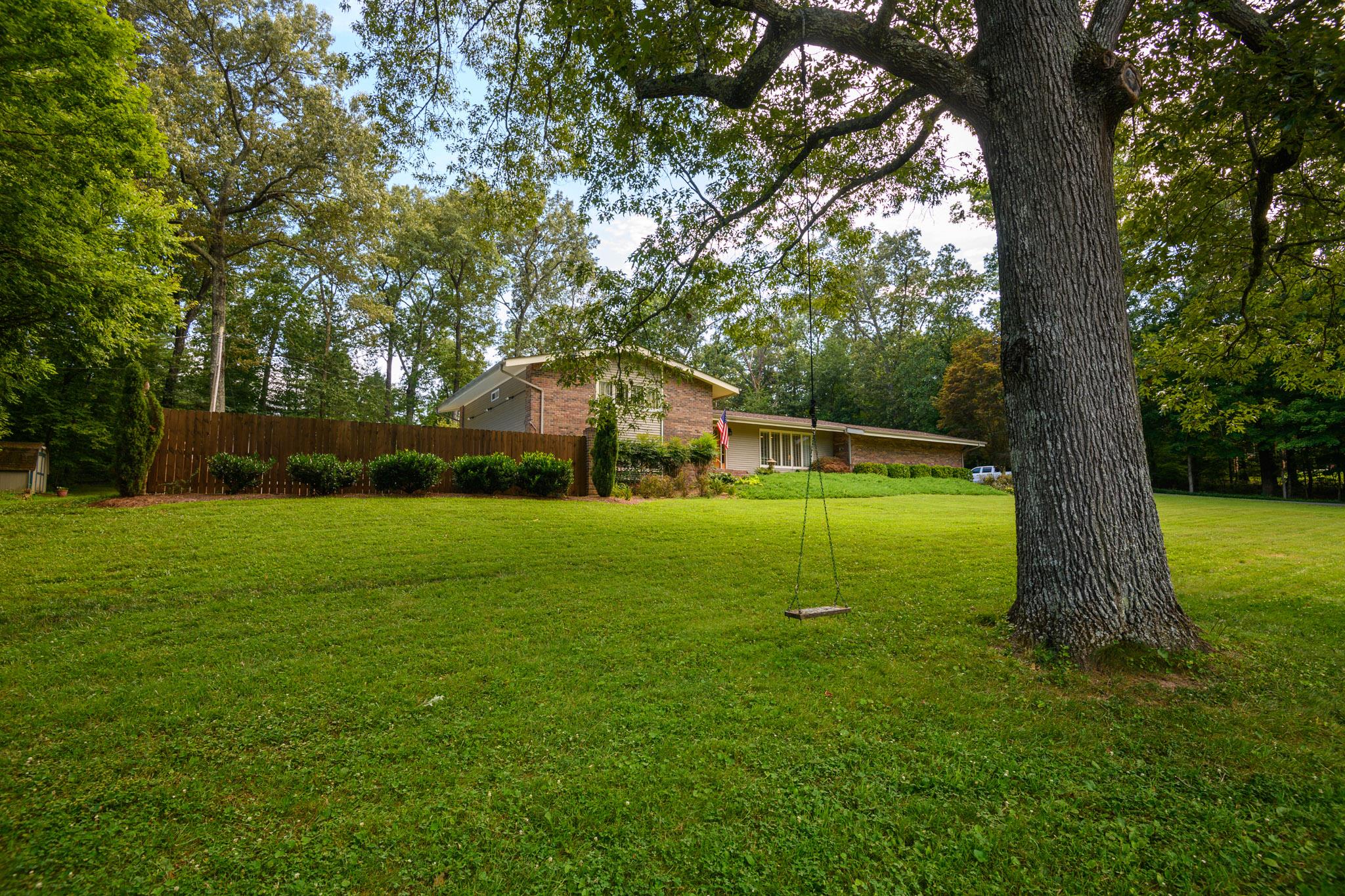 Large yard with mature trees  perfect for a swing