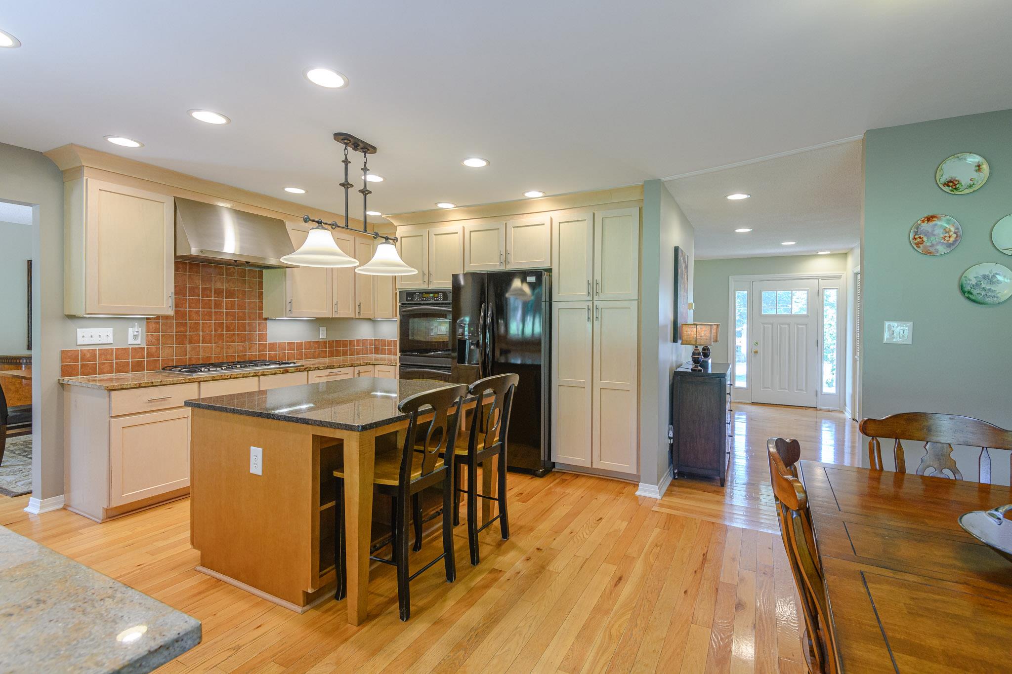 Island kitchen with room for bar stools and granite counter tops