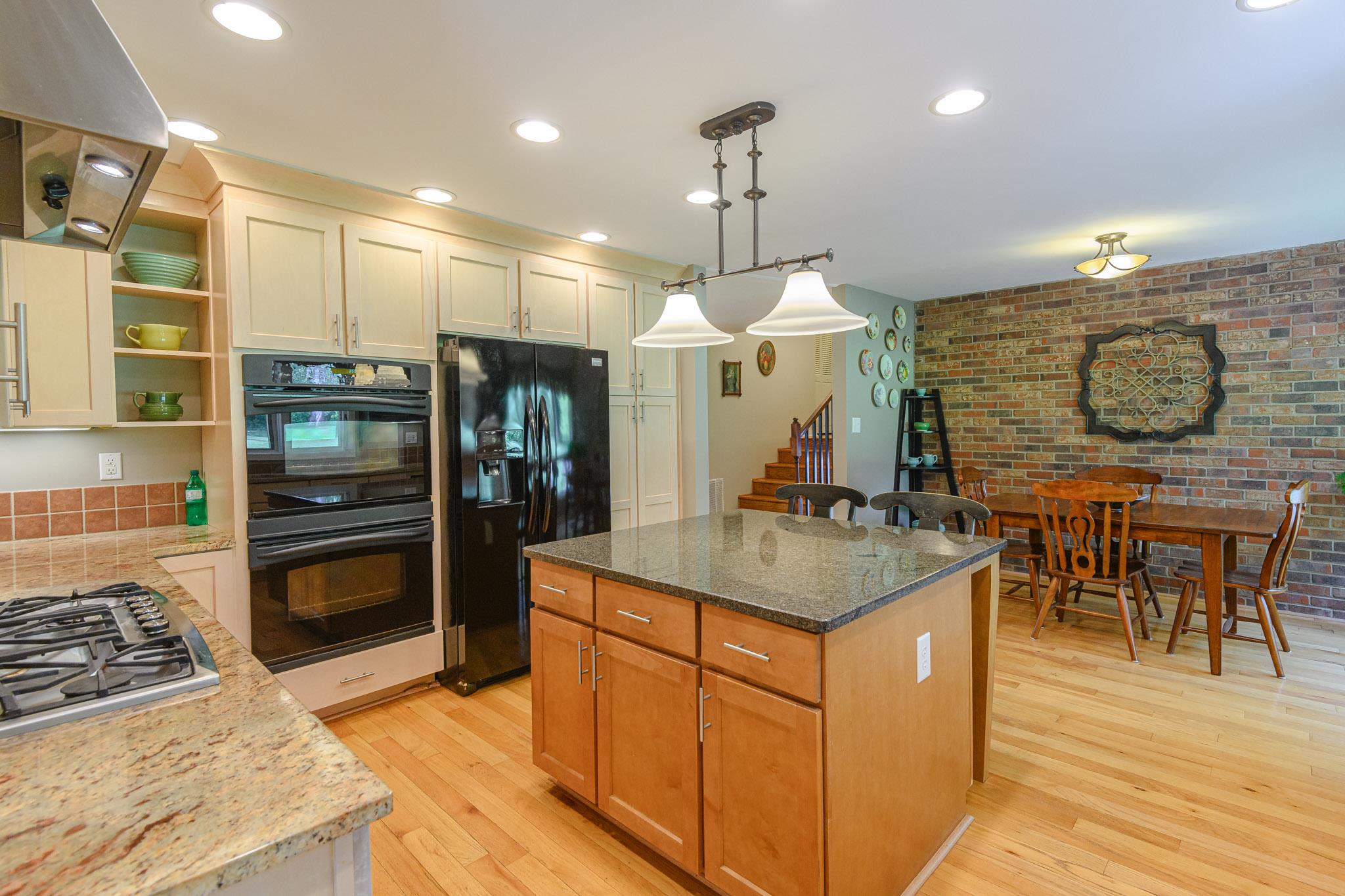 401 Lake Hills Road Tullahoma, TN 37388 - Photo 8 of 30 Double ovens and gas cook top- the breakfast nook has an exposed brick wall