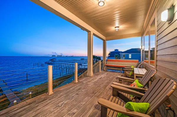 a view of a chairs and tables in the balcony