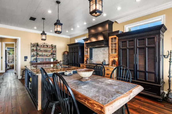 a kitchen with stainless steel appliances granite countertop a stove and a living room