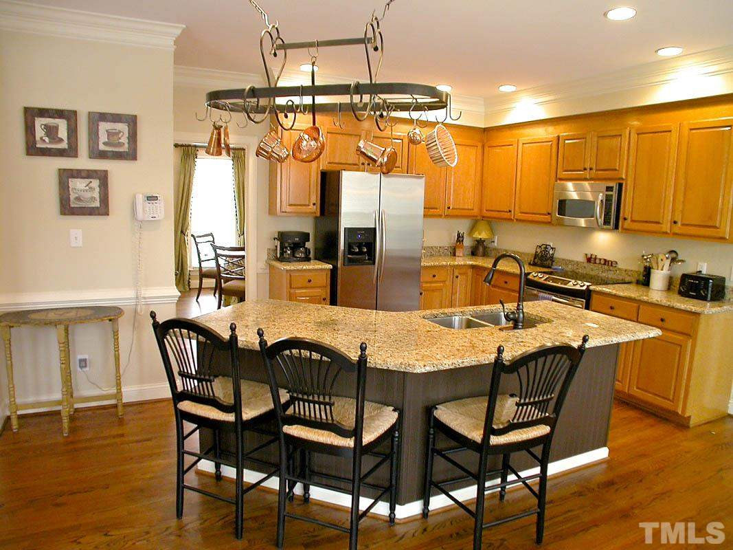 4000 Heathgate Lane Raleigh, NC 27613 - Photo 6 of 19 Open, spacious Kitchen with generous center island, granite counter tops, 42" cabinets, SS appliances and first of 2 pantries Kitchen