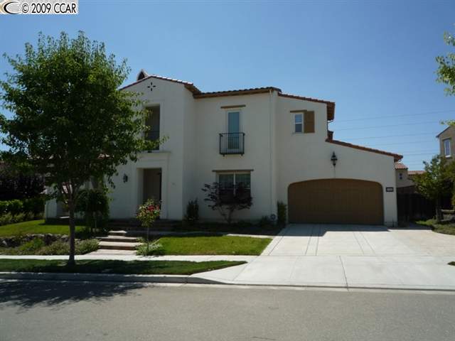 a front view of a house with a yard and a garage
