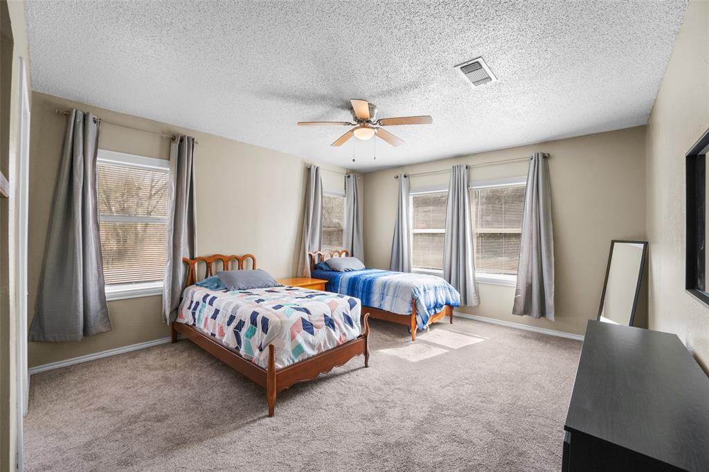 1145 Jefferson Road Paris, TX 75460 - Photo 10 of 17 a bed room with a bed and two large window