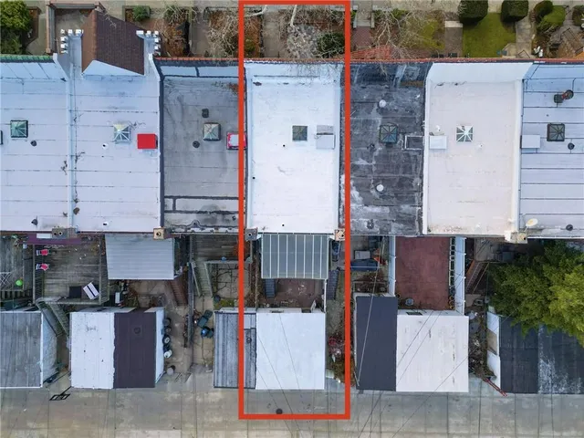 an aerial view of houses with an outdoor space