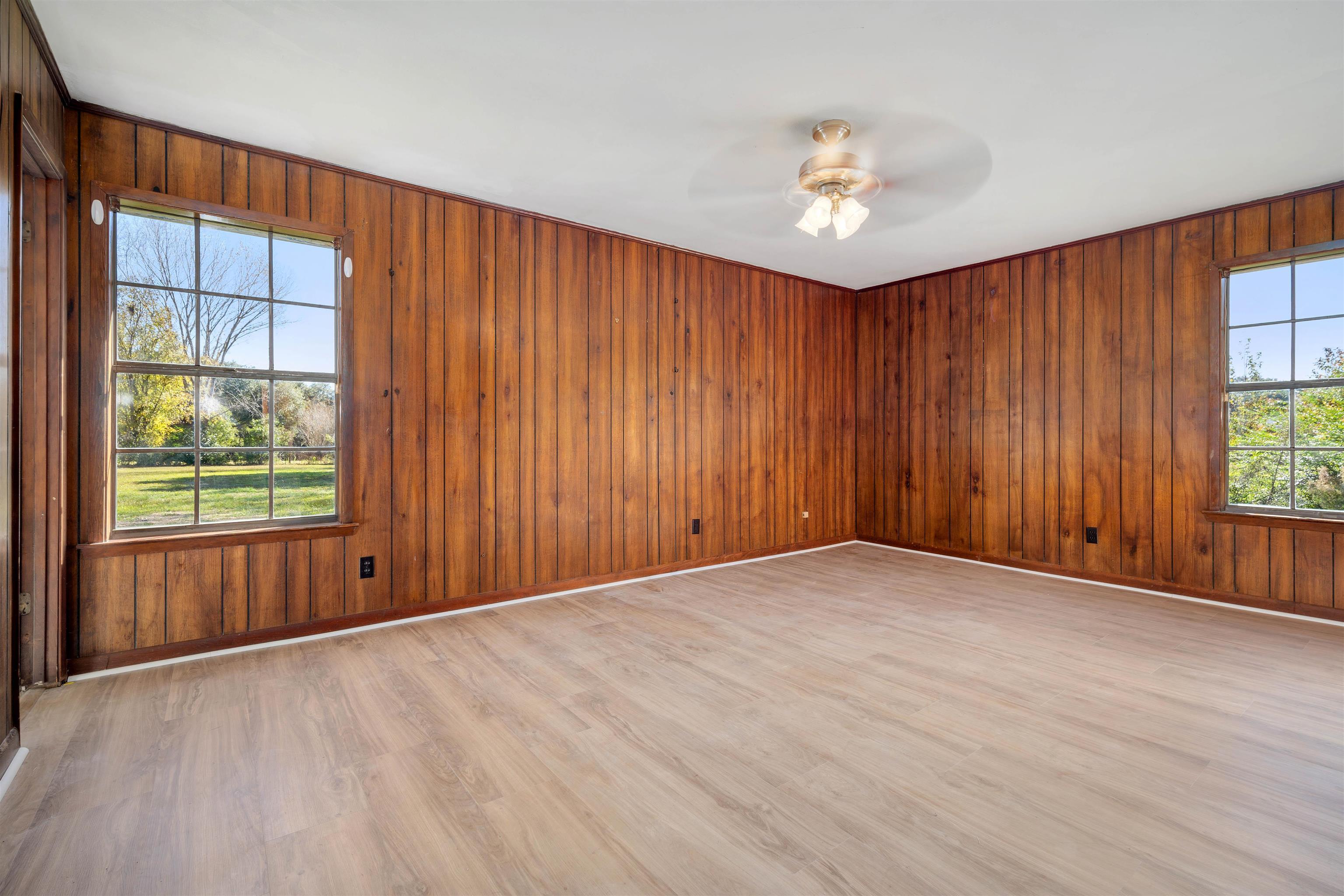 10285 Argyle Road Irvington, AL 36544 - Photo 16 of 28 Unfurnished room featuring wooden walls, light wood-style floors, and a ceiling fan