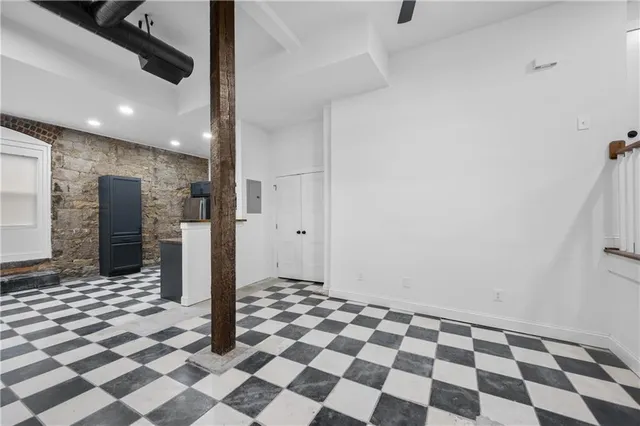 a bathroom with a black and white checkered floor