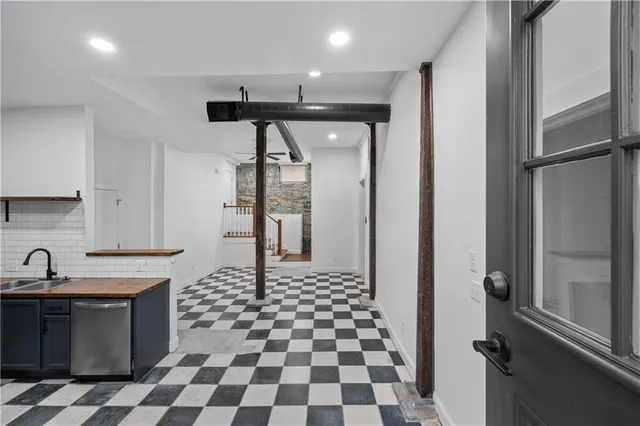 a kitchen with a refrigerator a sink and a cabinets