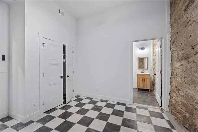 a view of a bathroom with a black and white checkered floor