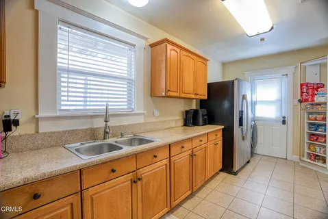 a kitchen with granite countertop cabinets and window