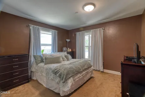 a bedroom with a bed and a dresser