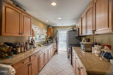 a kitchen with a sink a counter and a window