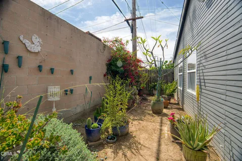 a view of a porch with chairs and potted plants