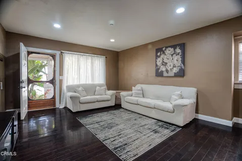 a dining room with furniture and wooden floor