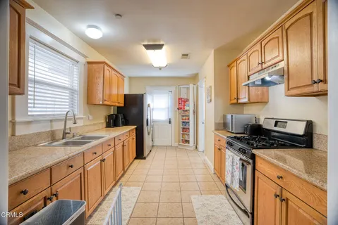 a kitchen with a sink cabinets and refrigerator