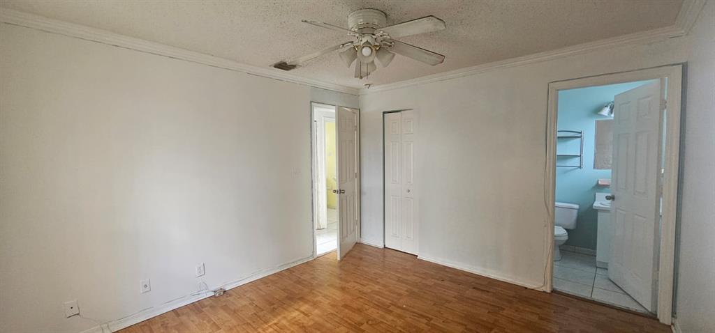 5580 Plunkett Street Hollywood, FL 33021 - Photo 8 of 13 a view of a room with a chandelier fan and closet
