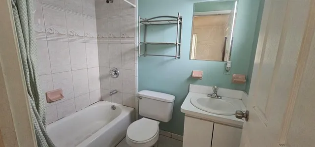 a white toilet sitting next to a bathroom sink