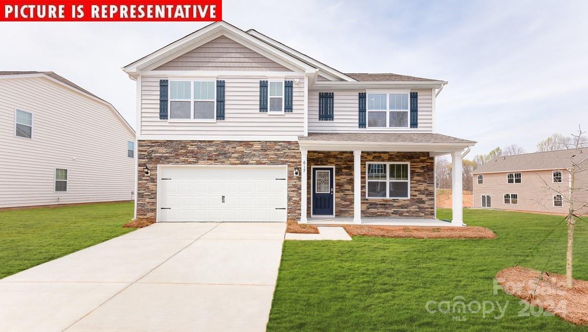 10881 Adair Wds Drive Davidson, NC 28036 - Photo 1 of 25 a front view of a house with a yard and garage