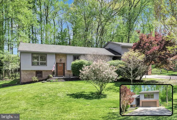 a view of a house with a yard and tree s