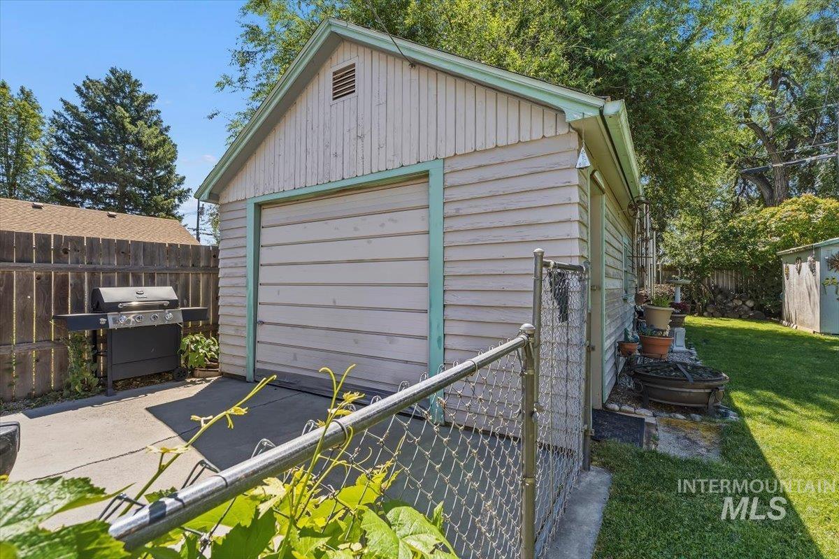 4619 Freemont Street Boise, ID 83706 - Photo 21 of 27 Detached single-car garage featuring horizontal siding and a roll-up door