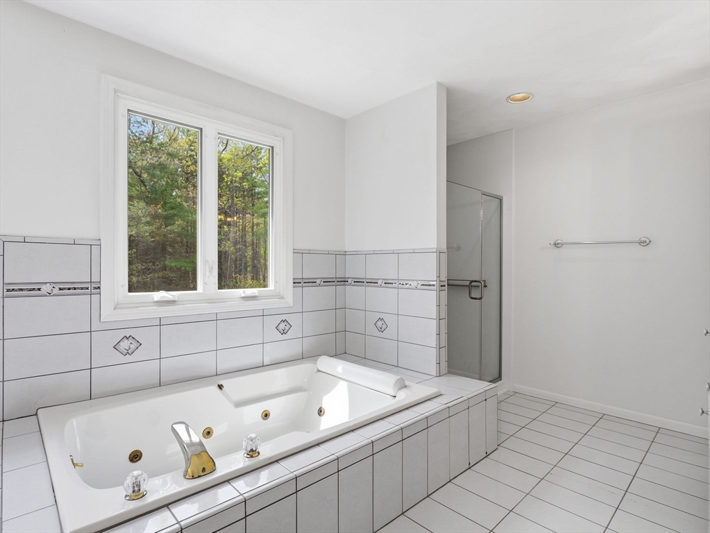 10 Hawk Ridge Road Andover, MA 01810 - Photo 22 of 32 a bathroom with a tub sink and window