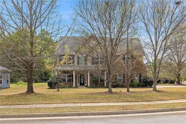 a front view of a house with a yard