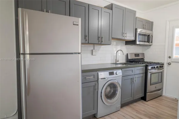 a white refrigerator freezer sitting inside of a kitchen